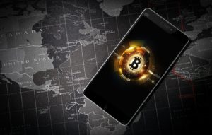 Telefon z logiem Bitcoin na tle mapy